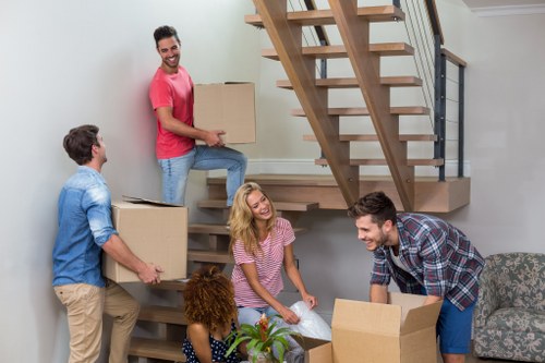 Furniture and boxes being moved from a flat in Earls Court with stair access