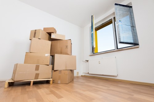 Removalists preparing items for transport from an Earls Court flat with narrow stair access