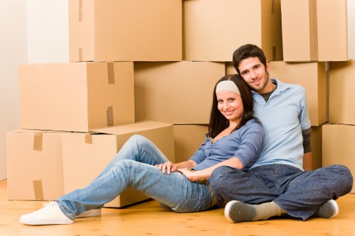 Professional movers handling furniture and boxed belongings during an Earls Court house move